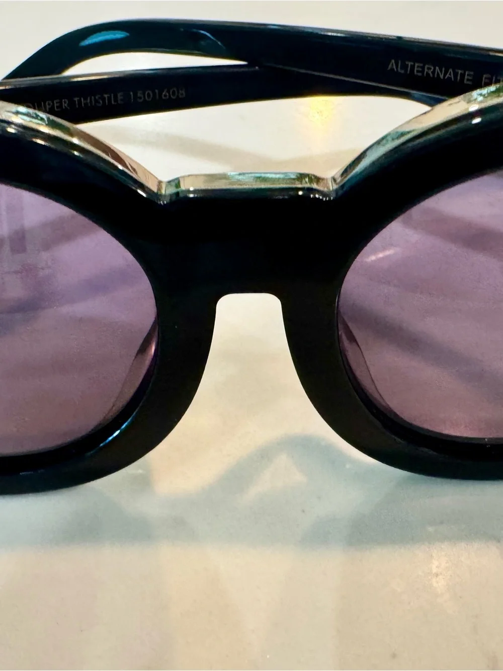 Karen Walker Black Round Sunglasses with Gold Detail and Purple Tint Lenses